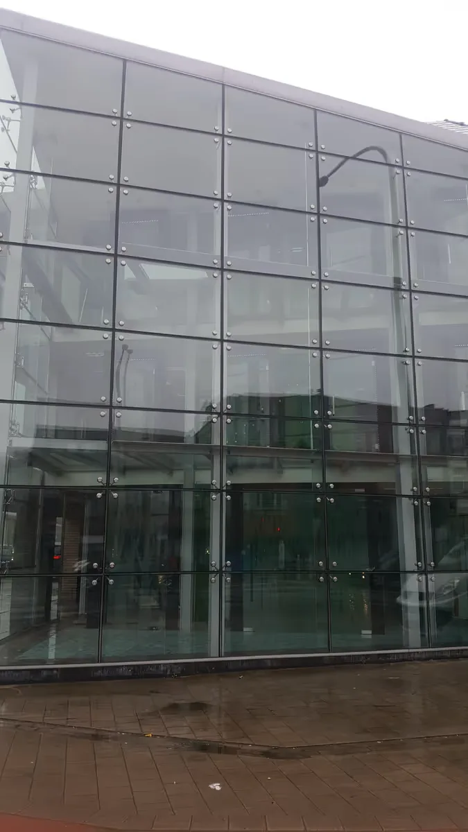 Gereinigde glazen gevel van een modern gebouw in Wommelgem
