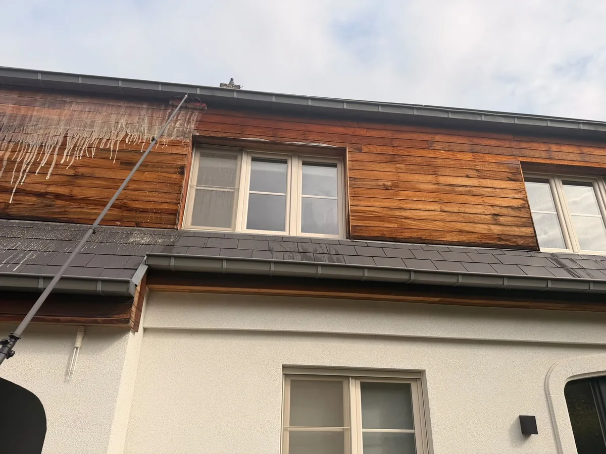 Houten bekleding van een dakverdieping, gereinigd met de telescoopsteel